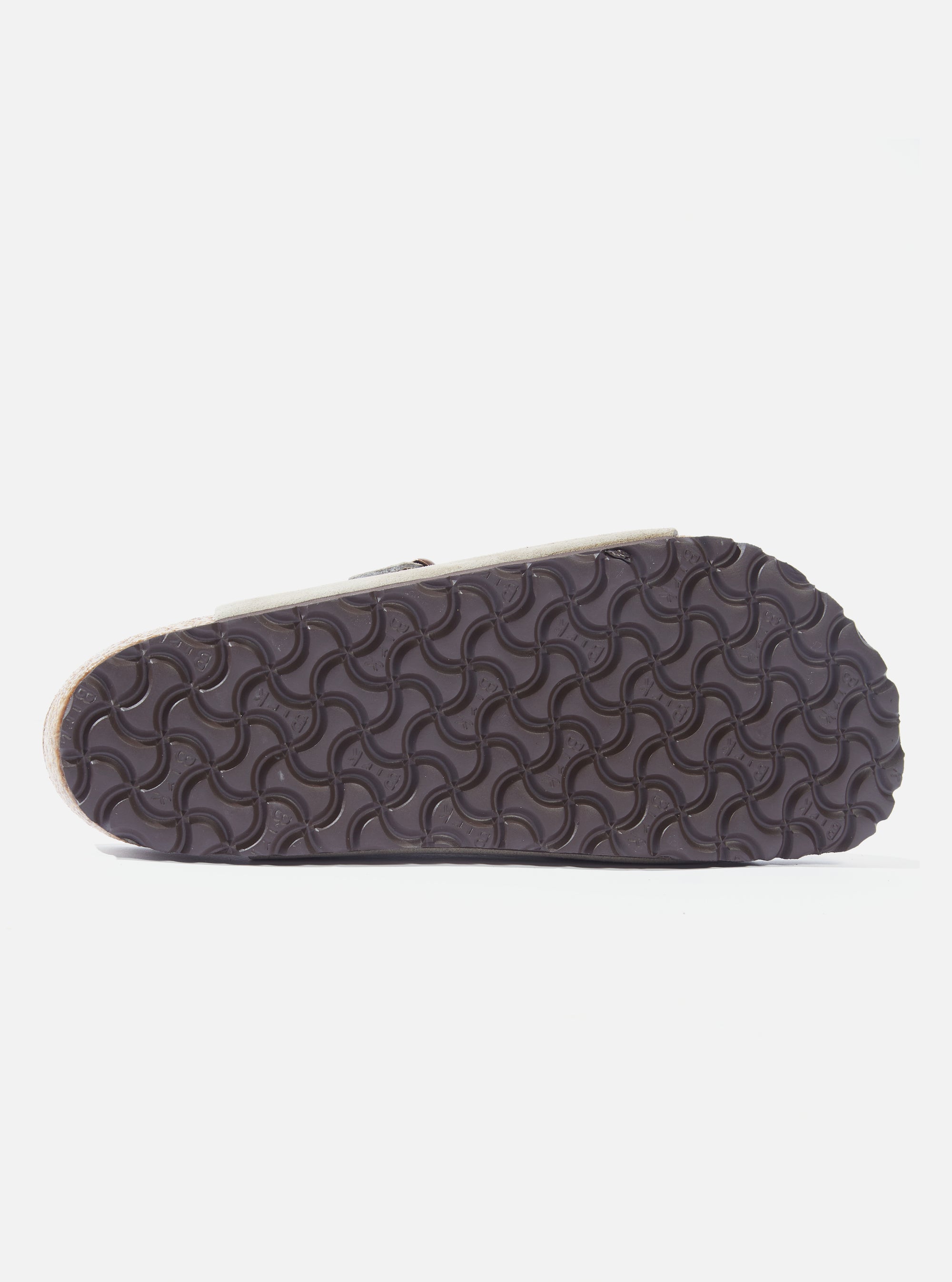 Close-up of the sole of a Birkenstock Taupe Suede Zürich sandal on a white background, showing the textured pattern.